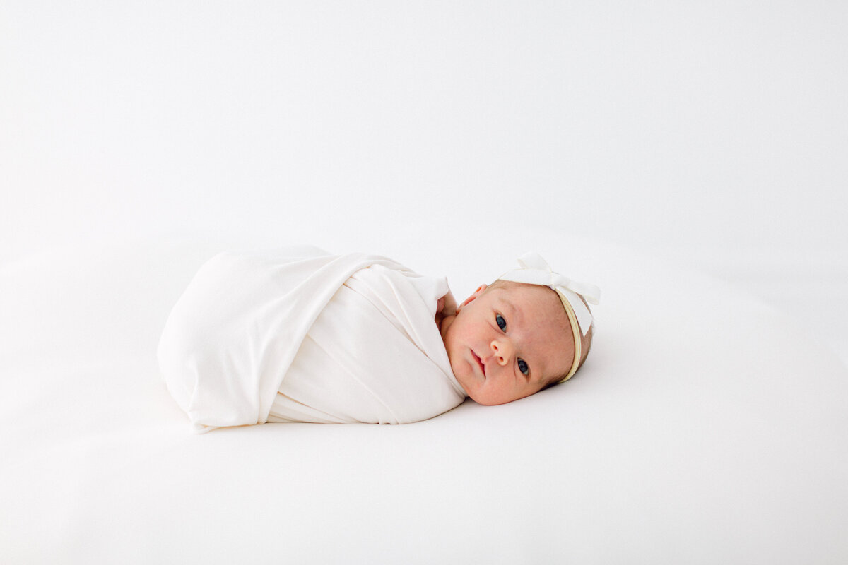 Photo of swaddled newborn baby by Cincinnati Newborn Photographer