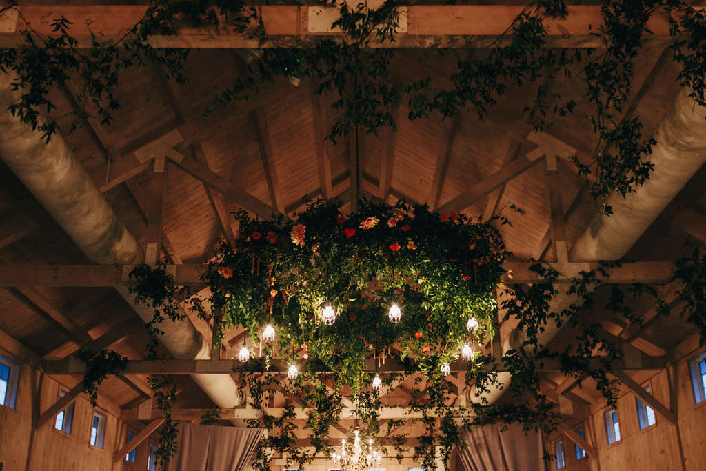 vines-flowers-hanging-from-barn-ceiling-beams