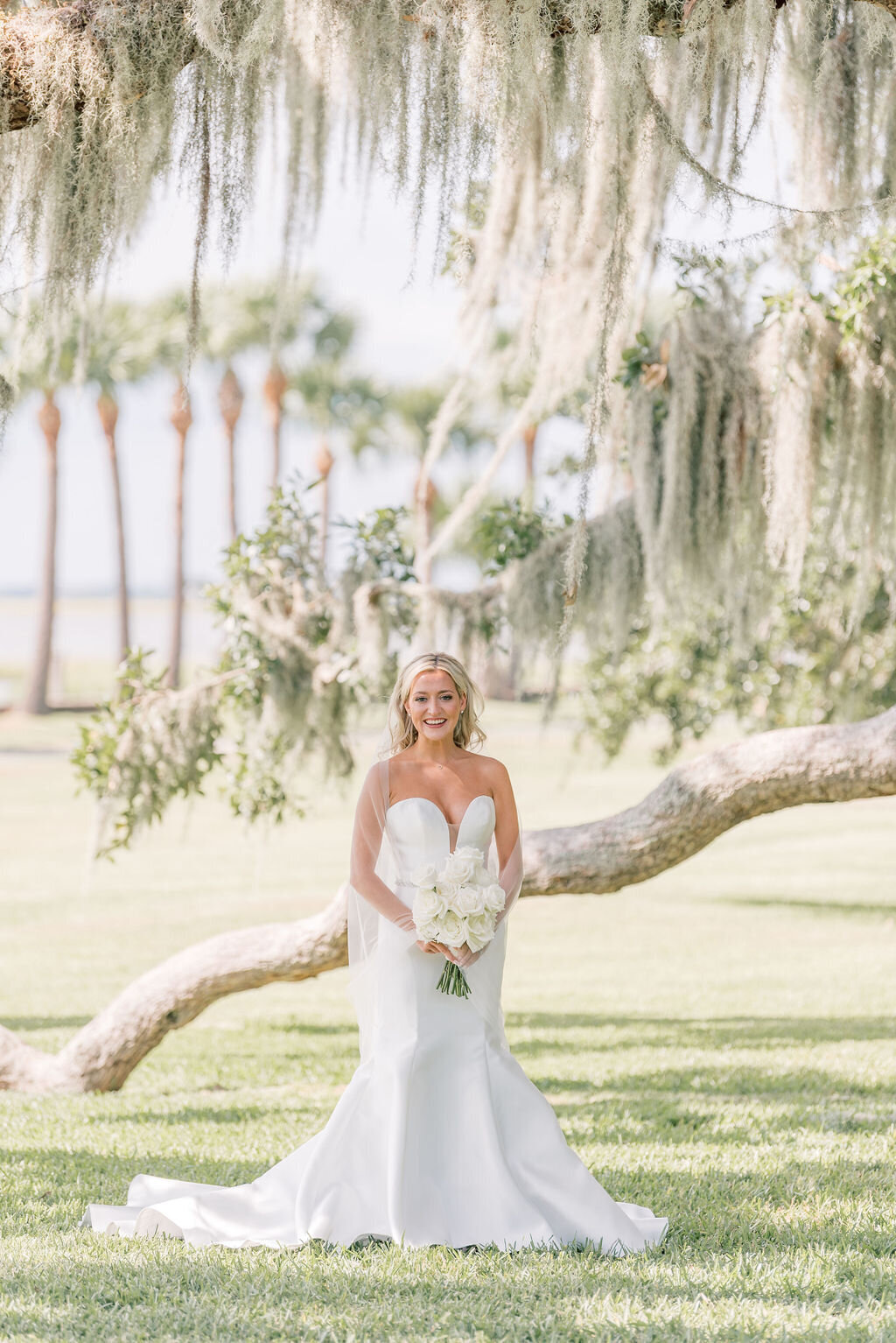 photo of bride in front of a tree with spanish moss by a beach taken by Jekyll Island Photographer, Rhonda Rowell