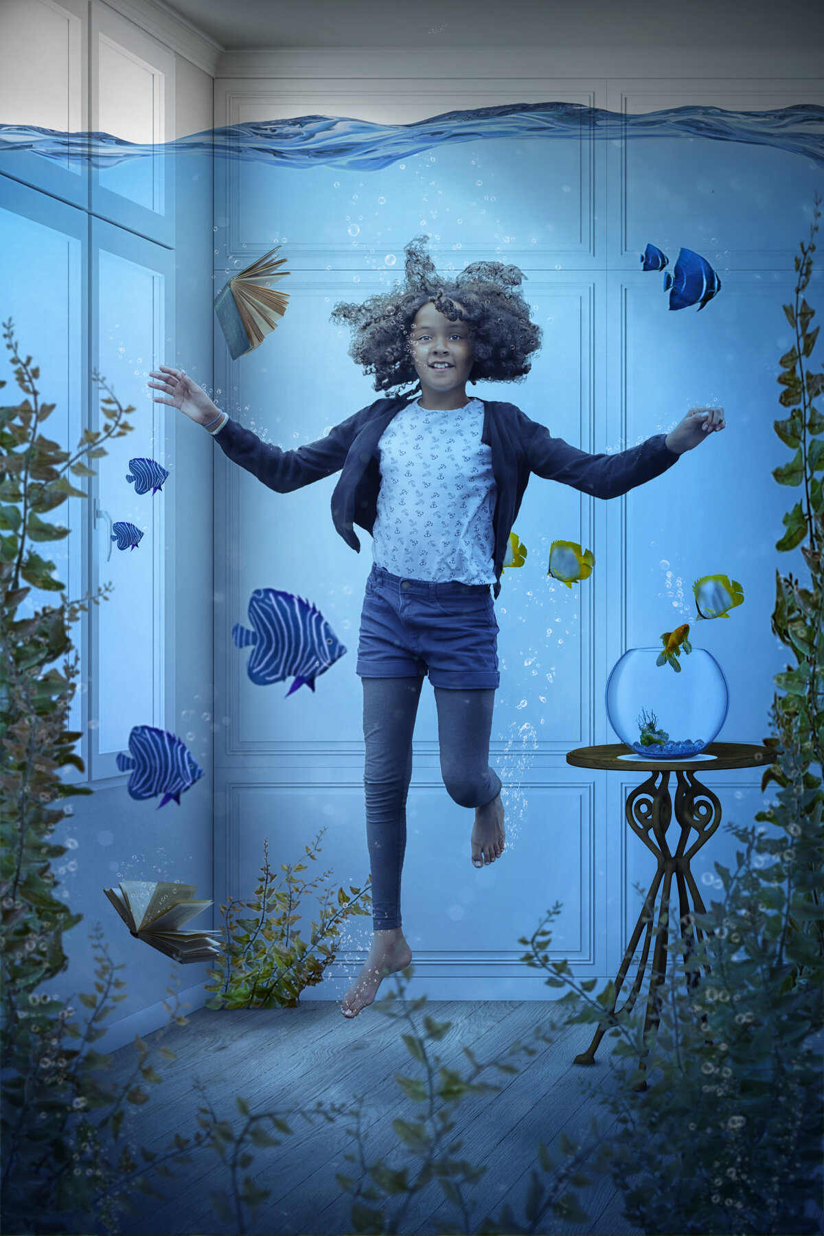 Girl floating underwater with fish in a room