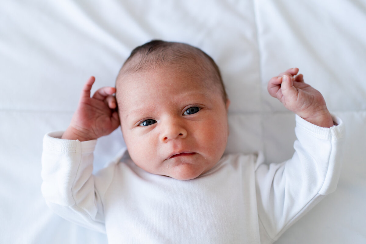 Newborn baby in white onesie in Natick, MA