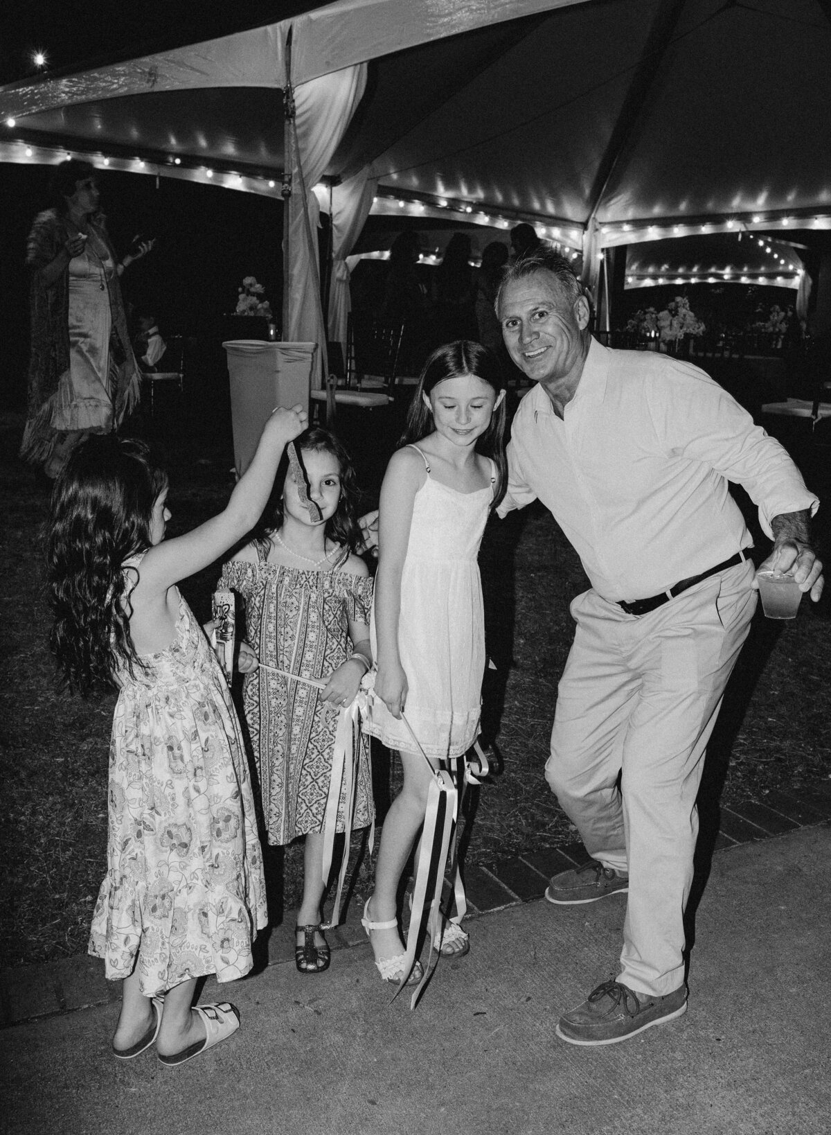 Man with 3 young girls at Umlauf Sculpture Garden, Austin