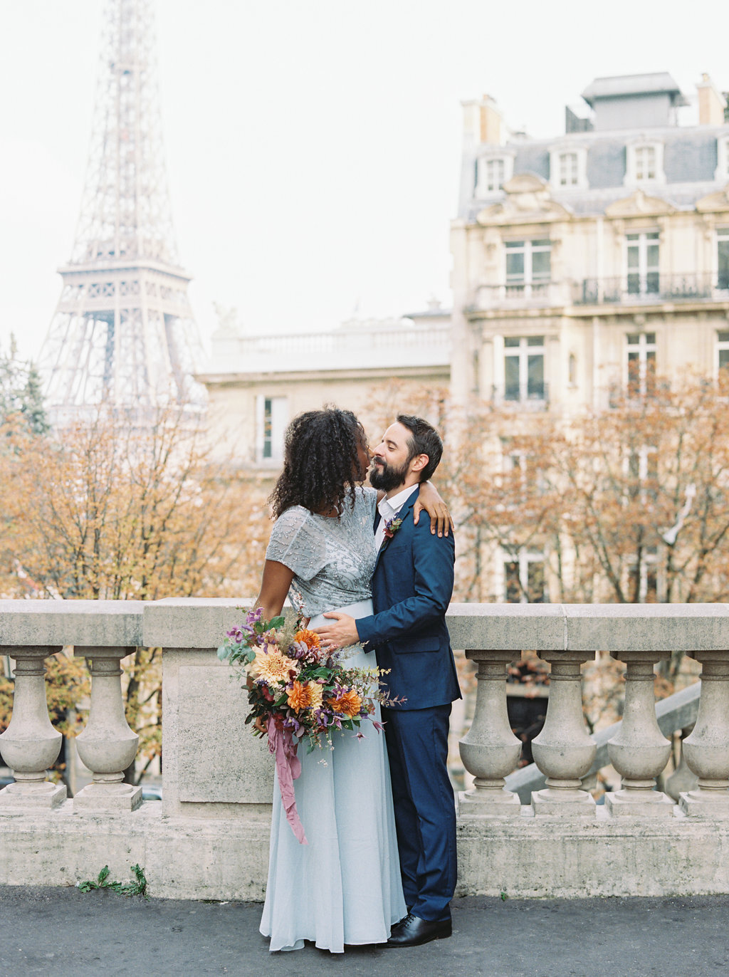 Intimate Paris Elopement--Natural, loose wedding floral design in hues of cream, burnt orange, mauve, and lavender composed of dahlias, rose, and natural greenery. Design by Rosemary and Finch.