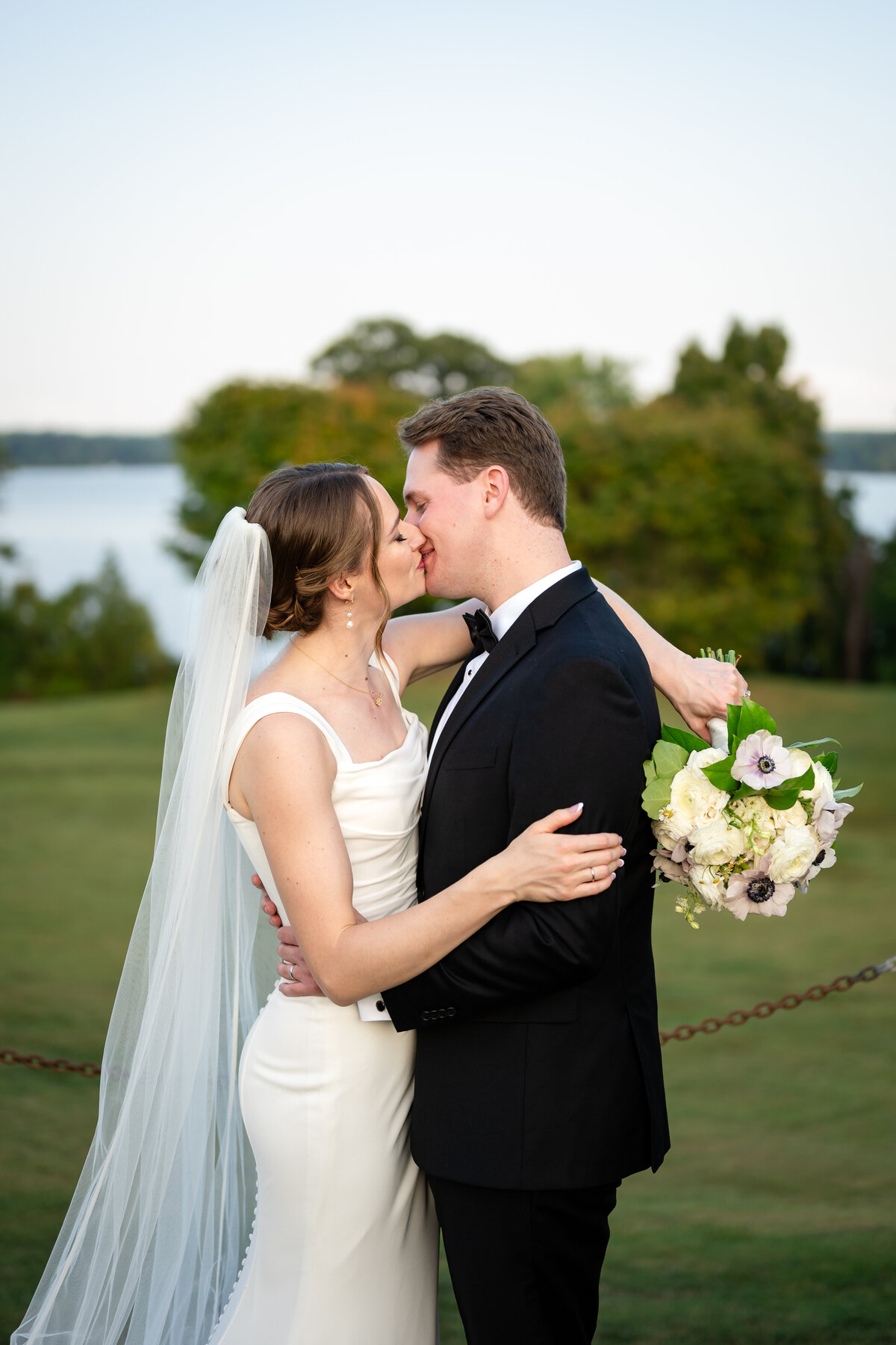 Emma and Adam kiss in outdoor wedding photo in Leesburg VA