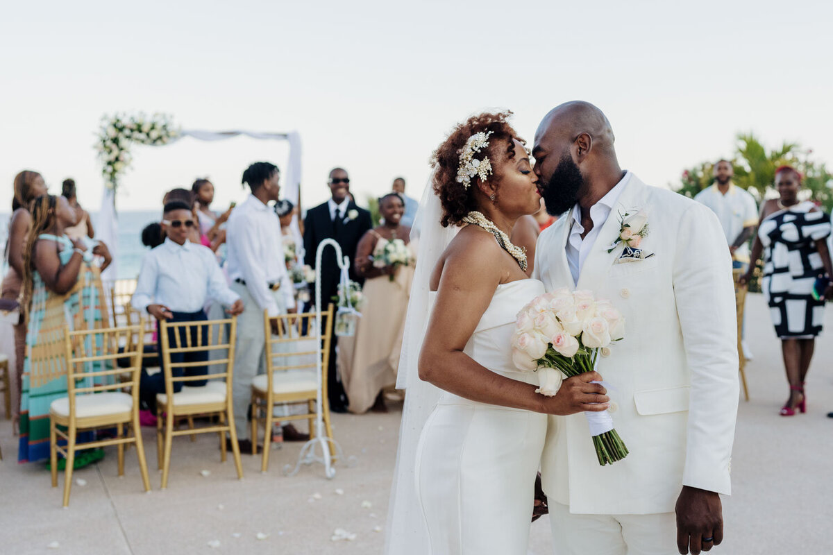Bride and groom kissing on their wedding ceremony