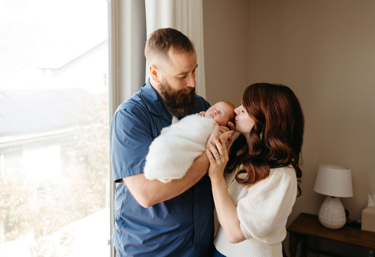 parent-poses-with-newborn