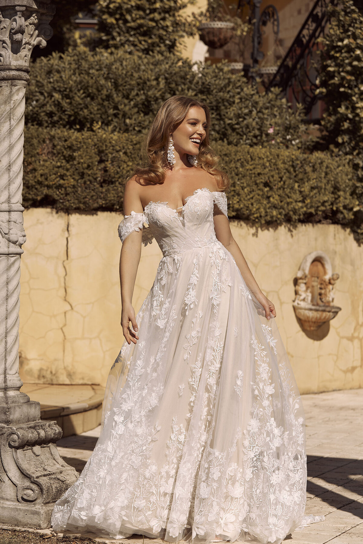 BRIELLE ML19255 FULL LENGTH A-LINE SILHOUETTE PLUNGING NECKLINE EMBROIDERED FLORAL LACE WITH DETACHABLE SHOULDER STRAPS AND TULLE CROSS OVER STRAPS FINISH WEDDING DRESS MADI LANE BRIDAL4 