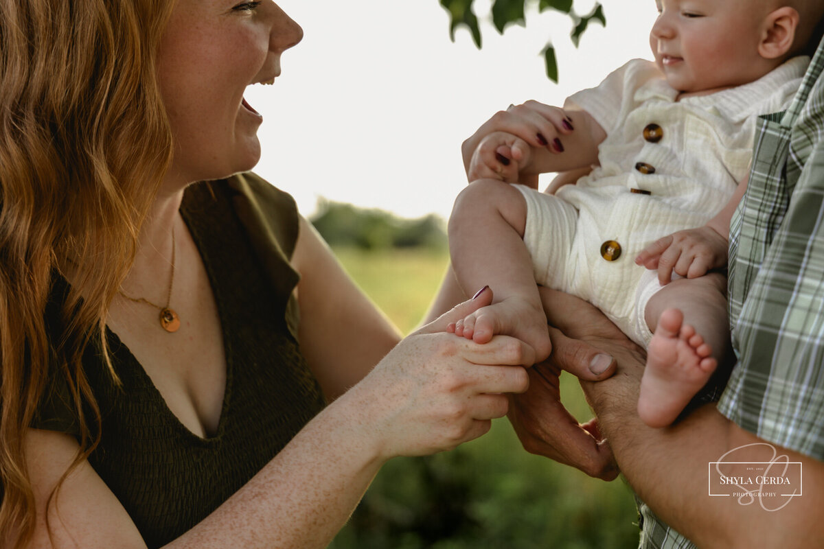 Mom laughing and playing with her baby