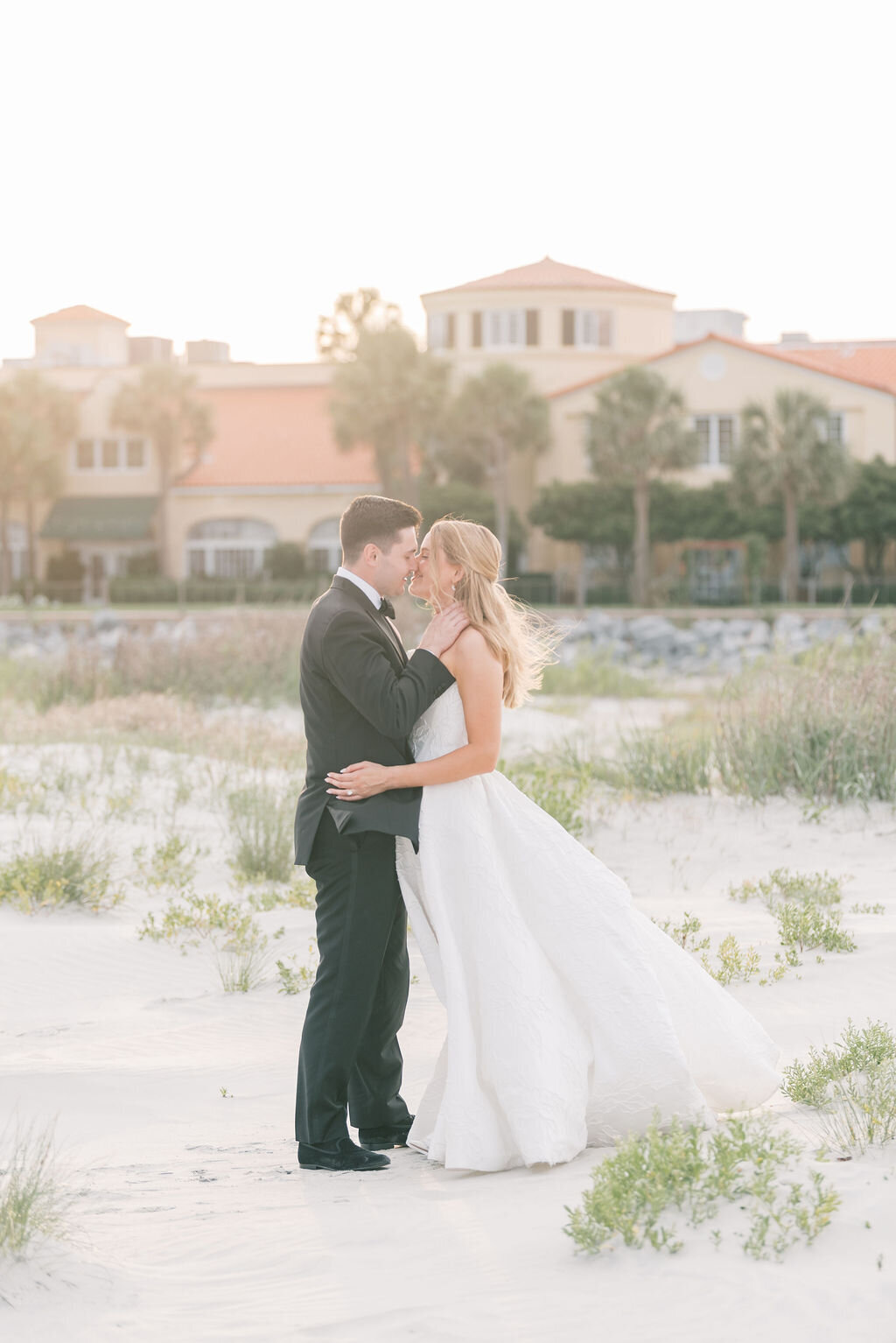 bride and groom facing each other about to kiss on the beach taken by St. Simons Island Wedding Photographer, Rhonda Rowell