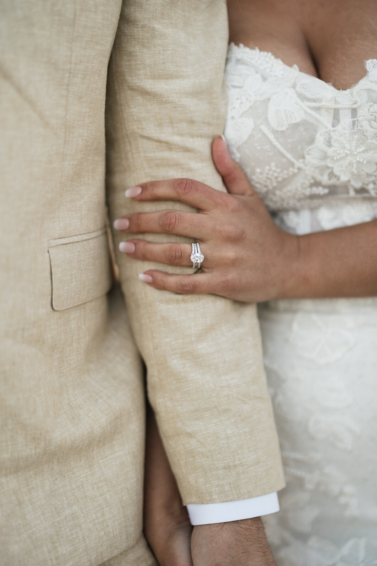 Bride and groom holding hands on beach during sunset at Hilton Beachfront Resort Santa Barbara