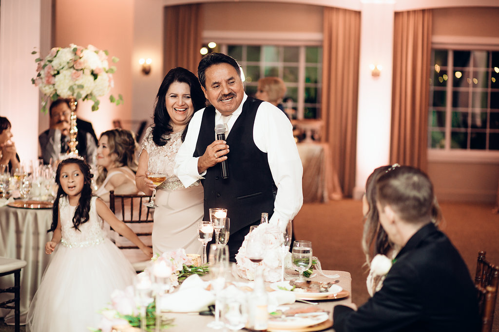 Wedding Photograph Of Man In Black Suit And Woman In Light Brown Dress Smiling At The Bride And Groom Los Angeles