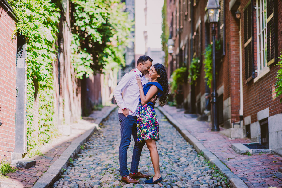 Engagement couple share a moment in the middle of the acorn street in boston