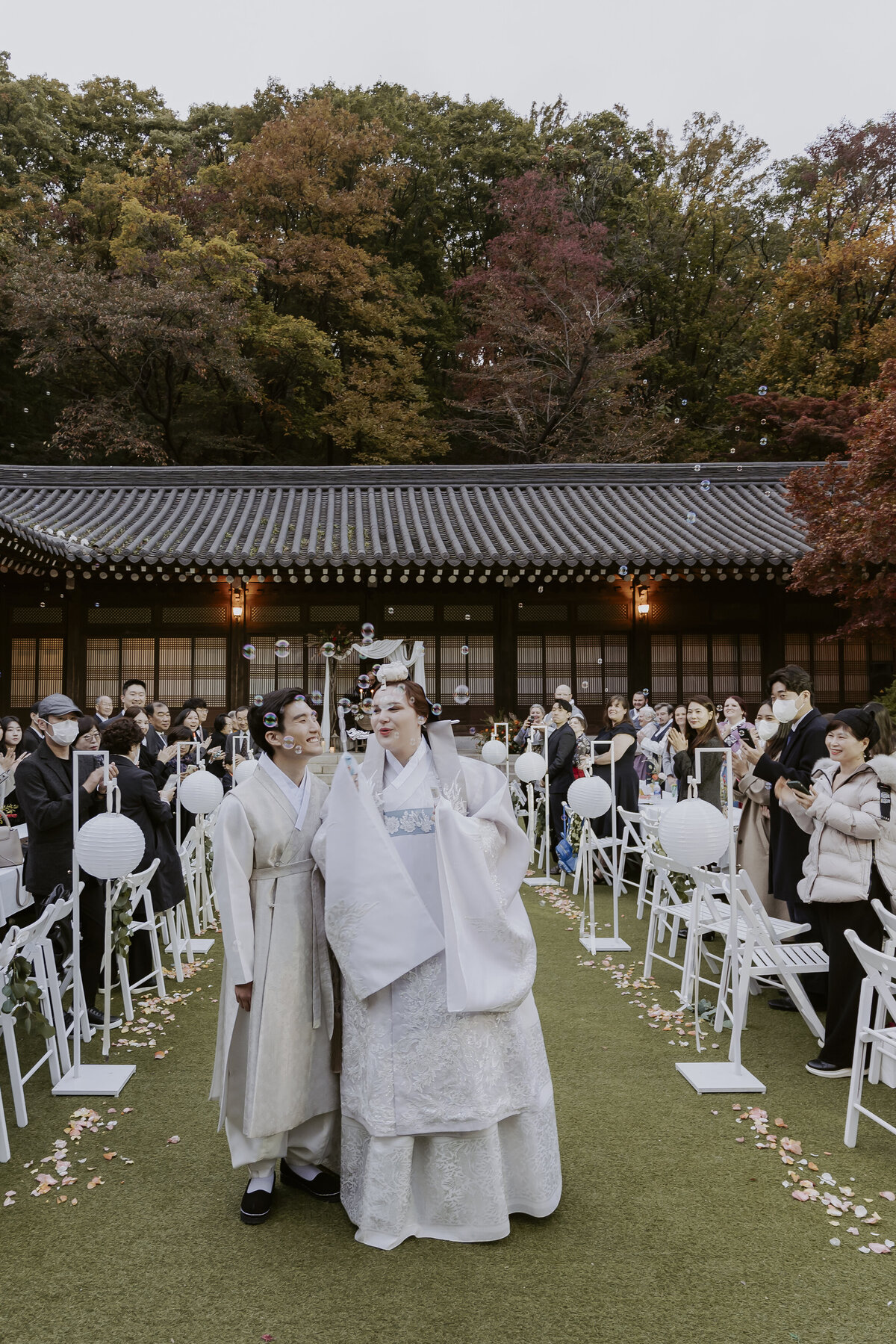 wedding ceremony exit with bride and groom blowing bubbles