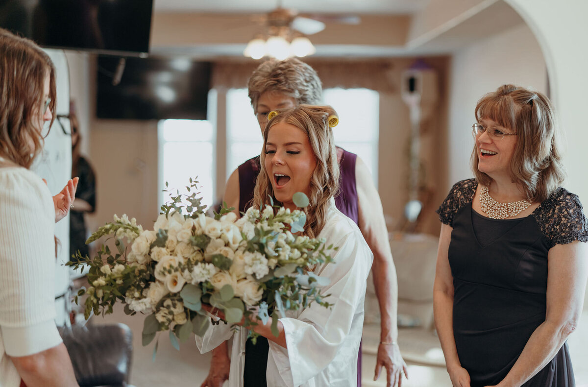 wedding guests giving a bride flowers