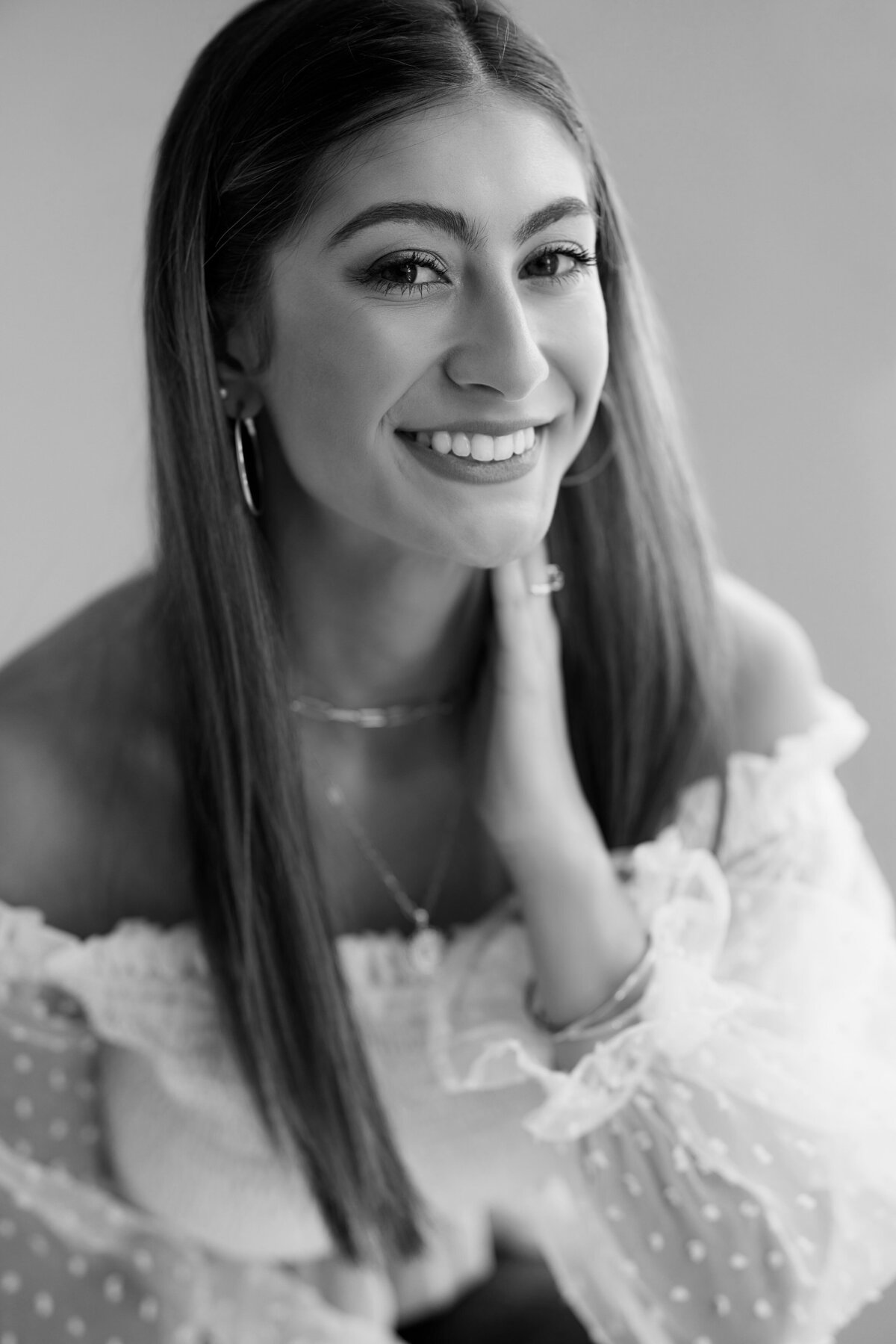 A young girl smiling in black and white