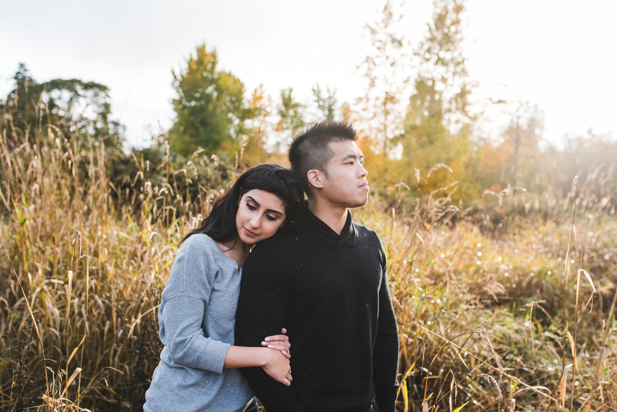 Couple standing together in high grass