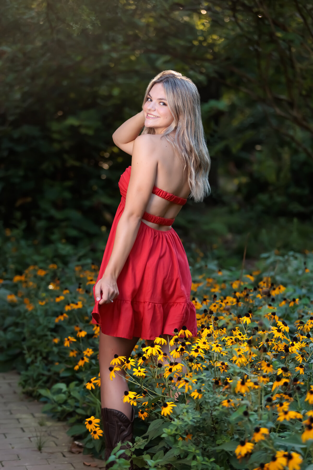 Dancing in the black eyed susans in the summer wearing a red dress.