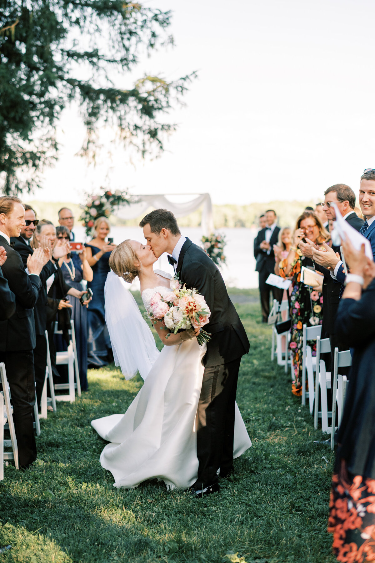 Couple kissing in the aisle after their delaware wedding ceremony