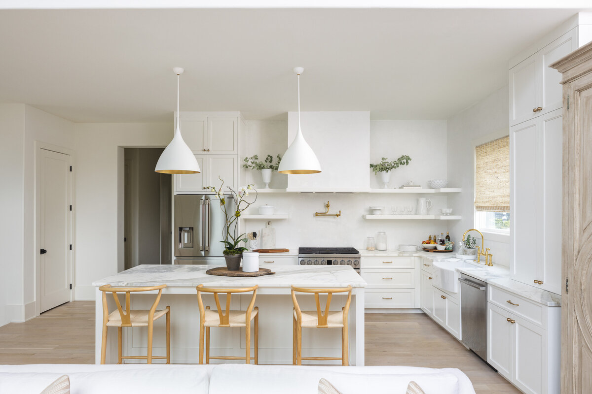 Modern white farmhouse kitchen with light wood accents