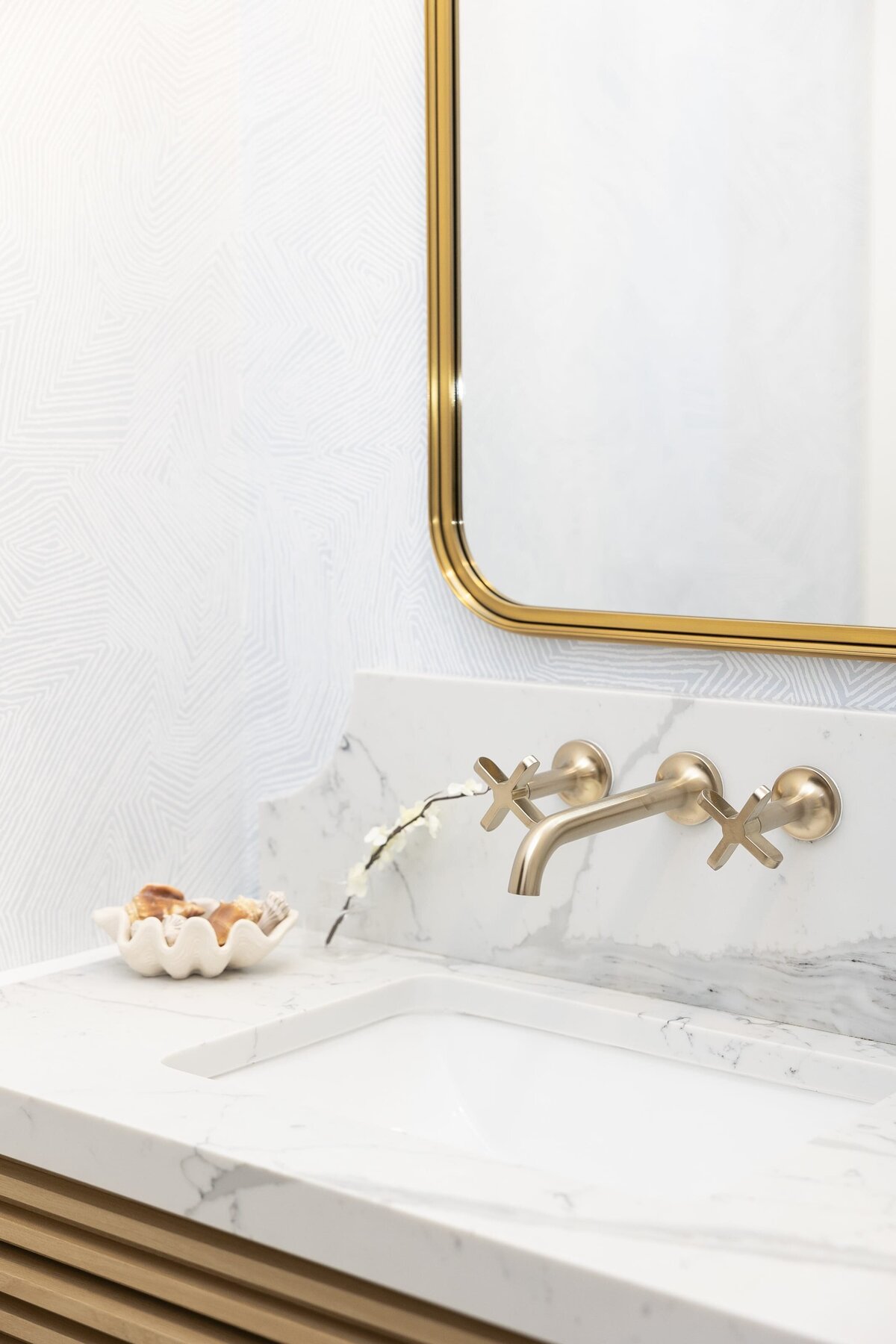 dewine design orlando interior designer contemporary coastal powder bathroom marble counter with gold framed mirror