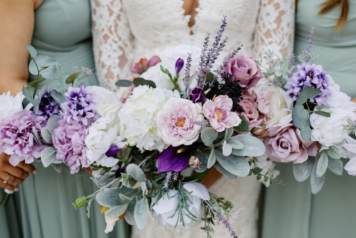 photograph of bride and brides maid's wedding day spring colored bouquets