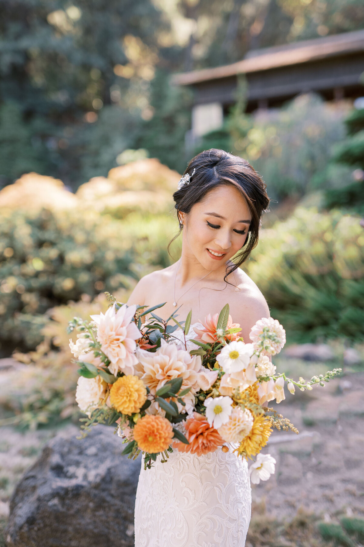 bride smiling at bouquet