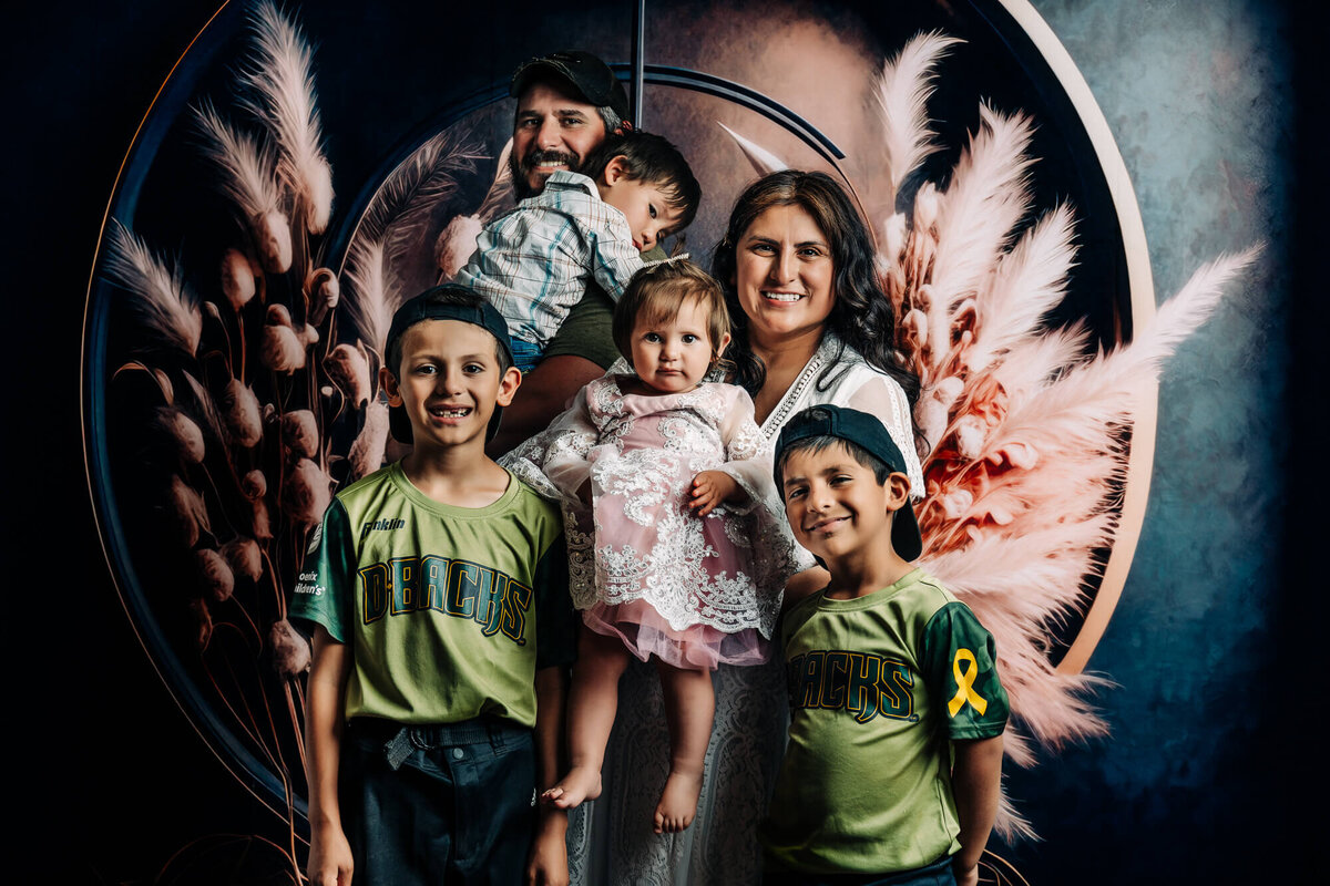 Family poses in boho themed session in Prescott family photography studio