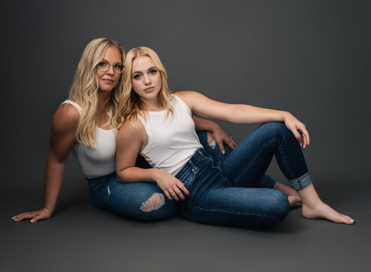 Elegant and stylish portrait of two women, captured in a modern studio setting by Leslie Q Photography
