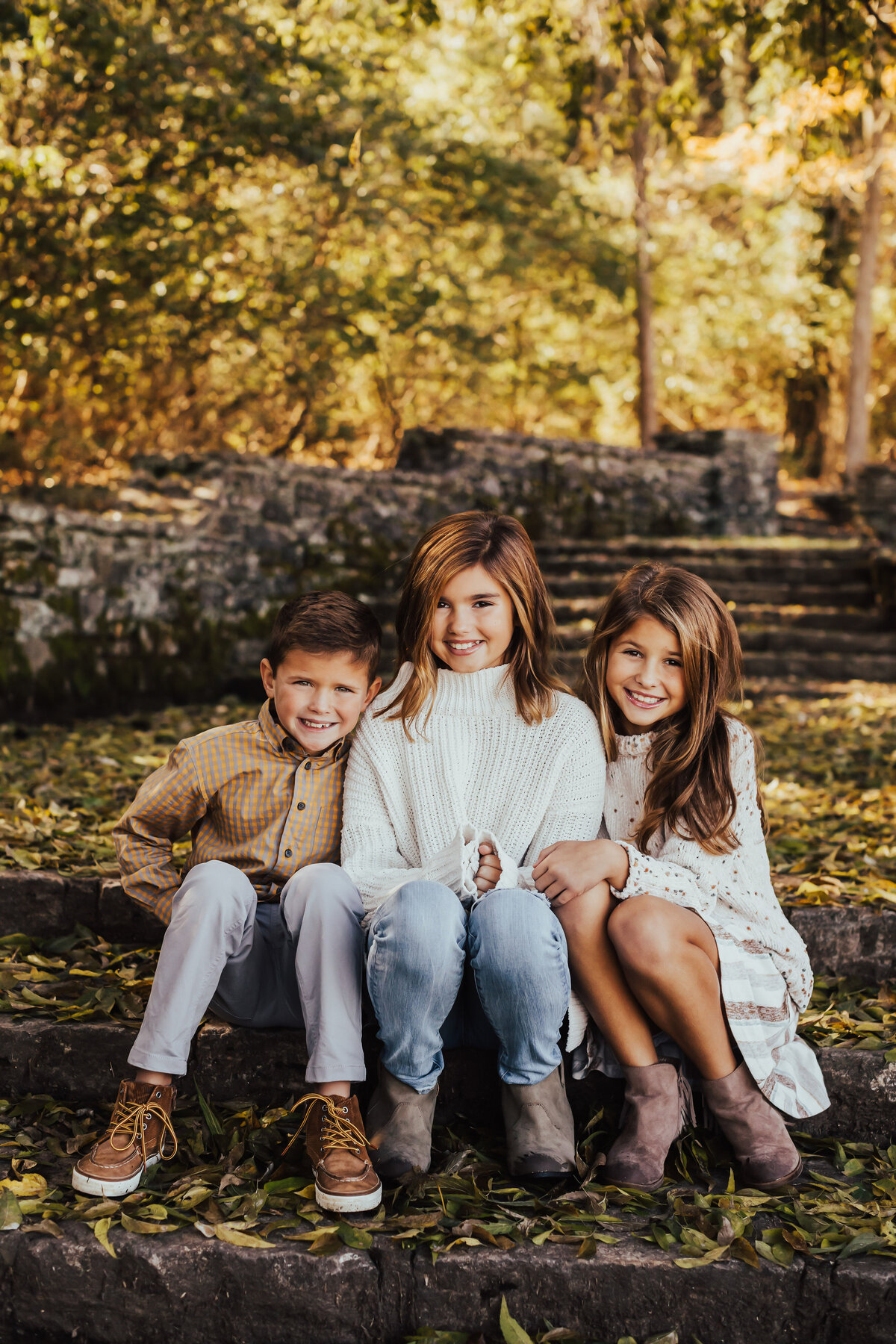 kids portrait with fall leaves on stairs