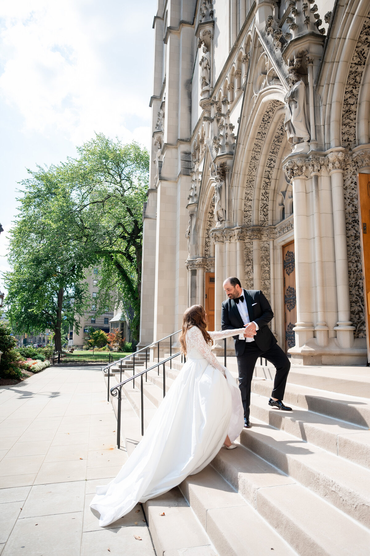 bride walking up the staircase entrance at st paul cathedral pittsburgh