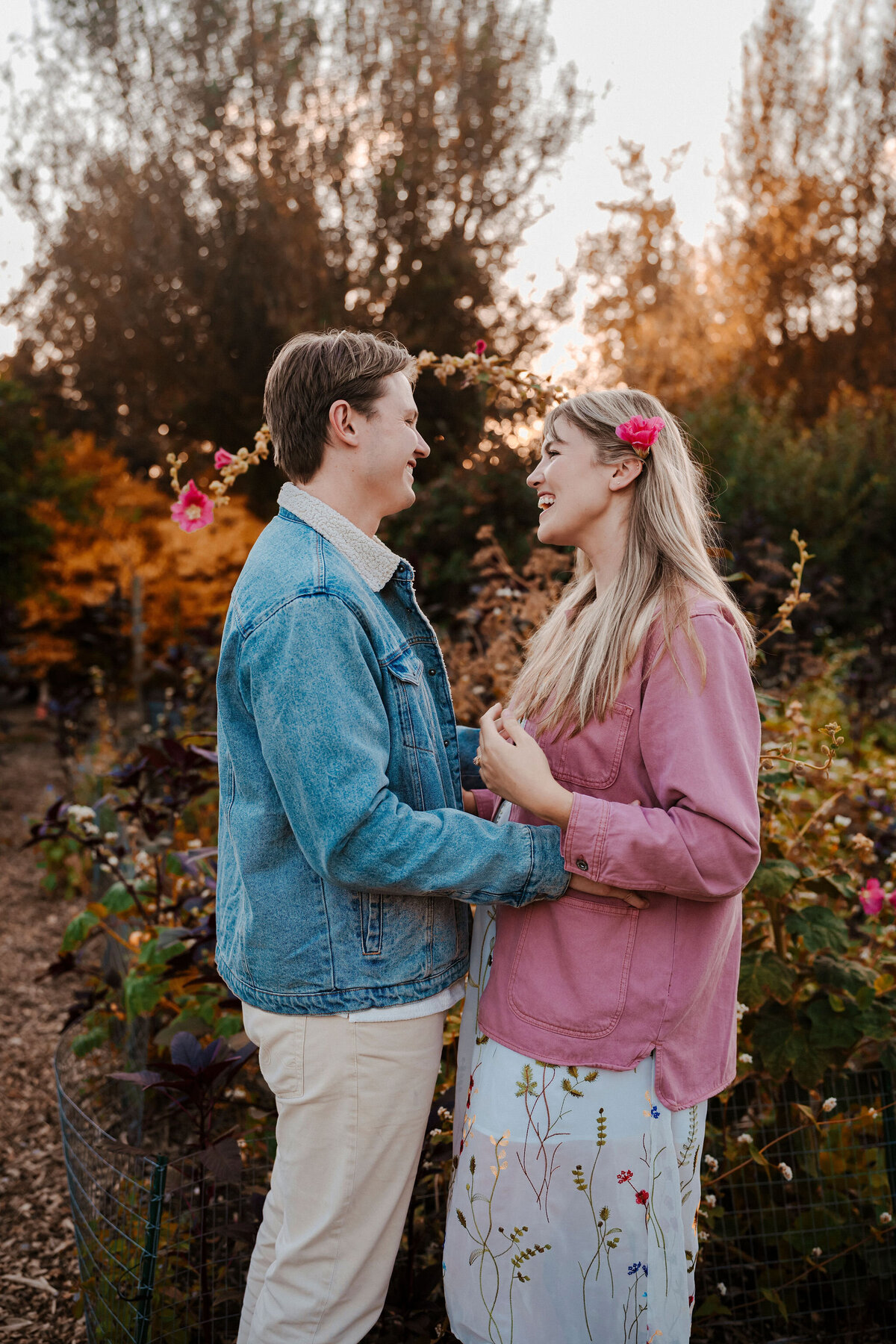 an engaged couple smiling at each other