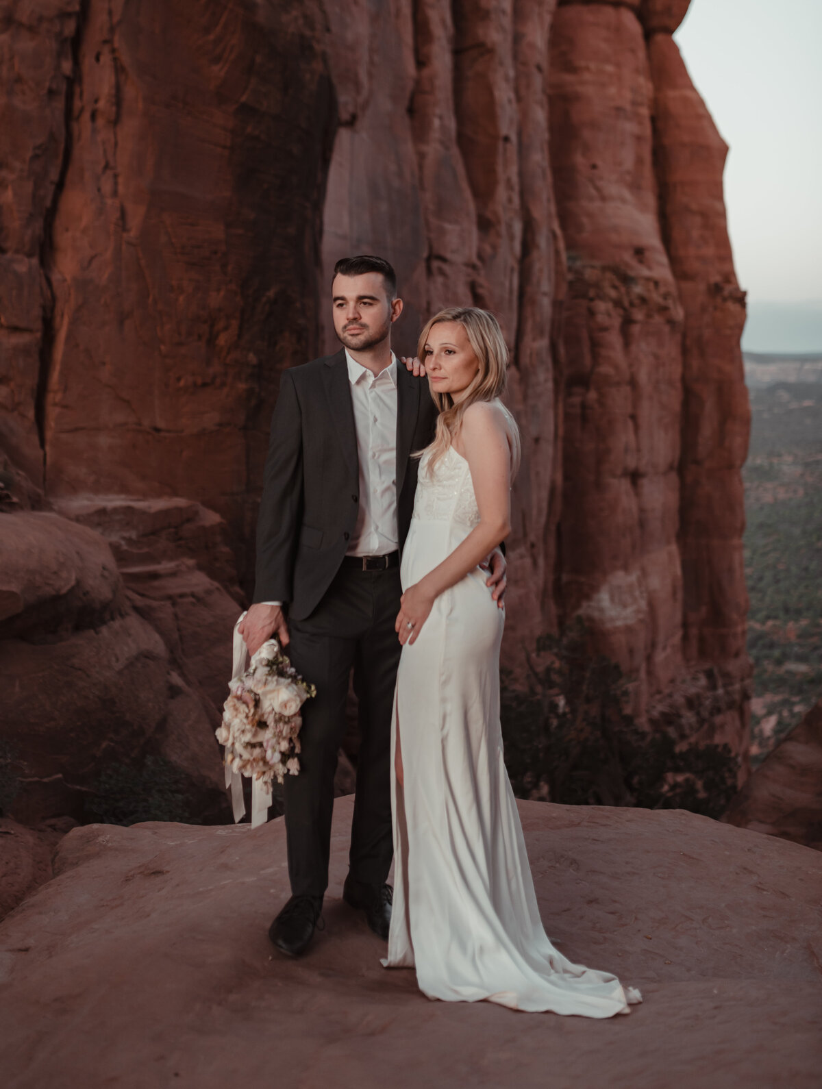 Couple sharing champagne toast after elopement Sedona taken by Kollar Photography