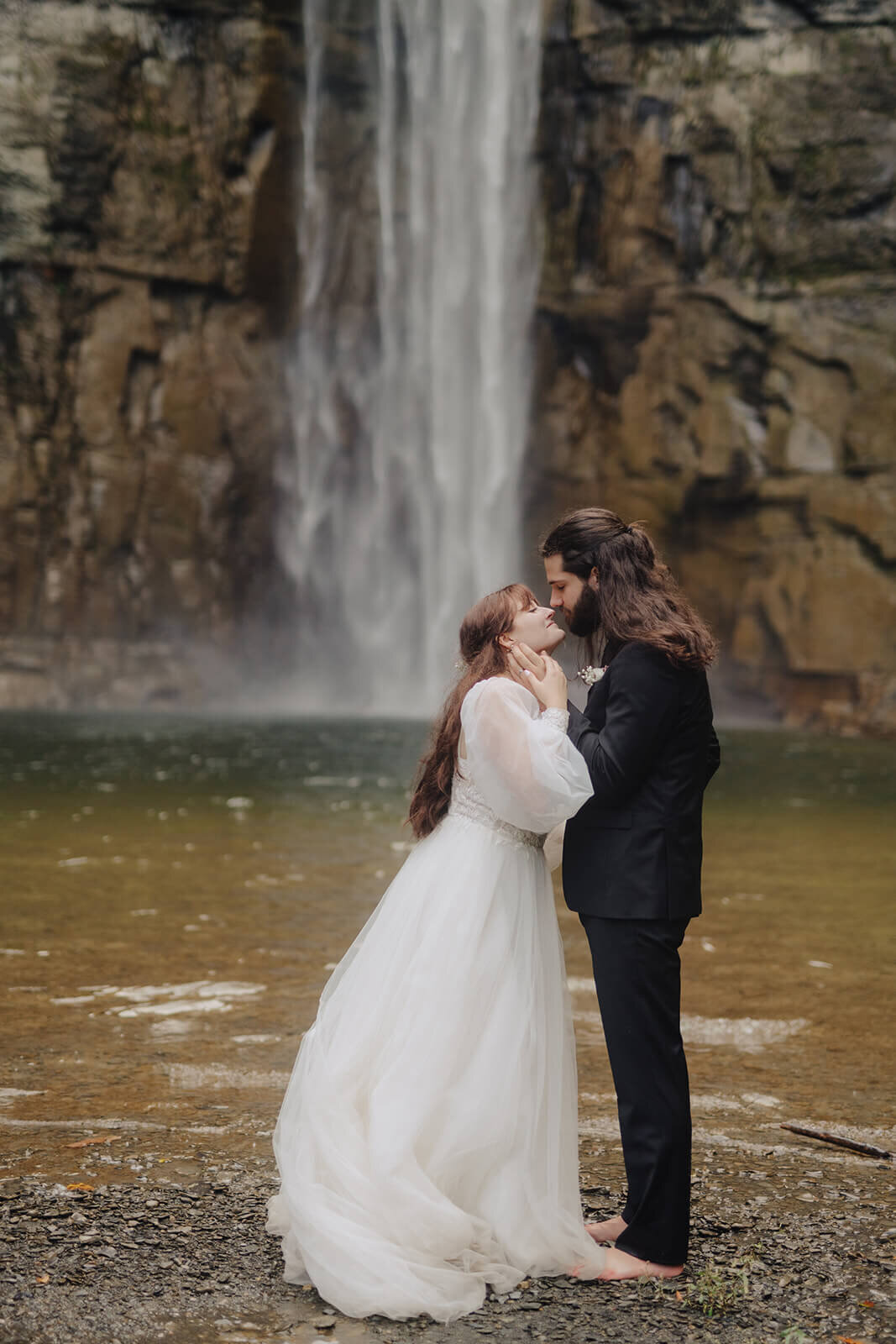 Bride and groom in front of waterfall at Finger Lakes wedding, NY
