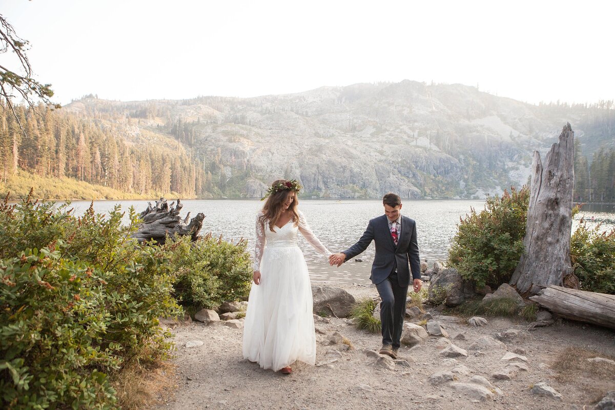 Newlyweds holding hands at Castle Lake