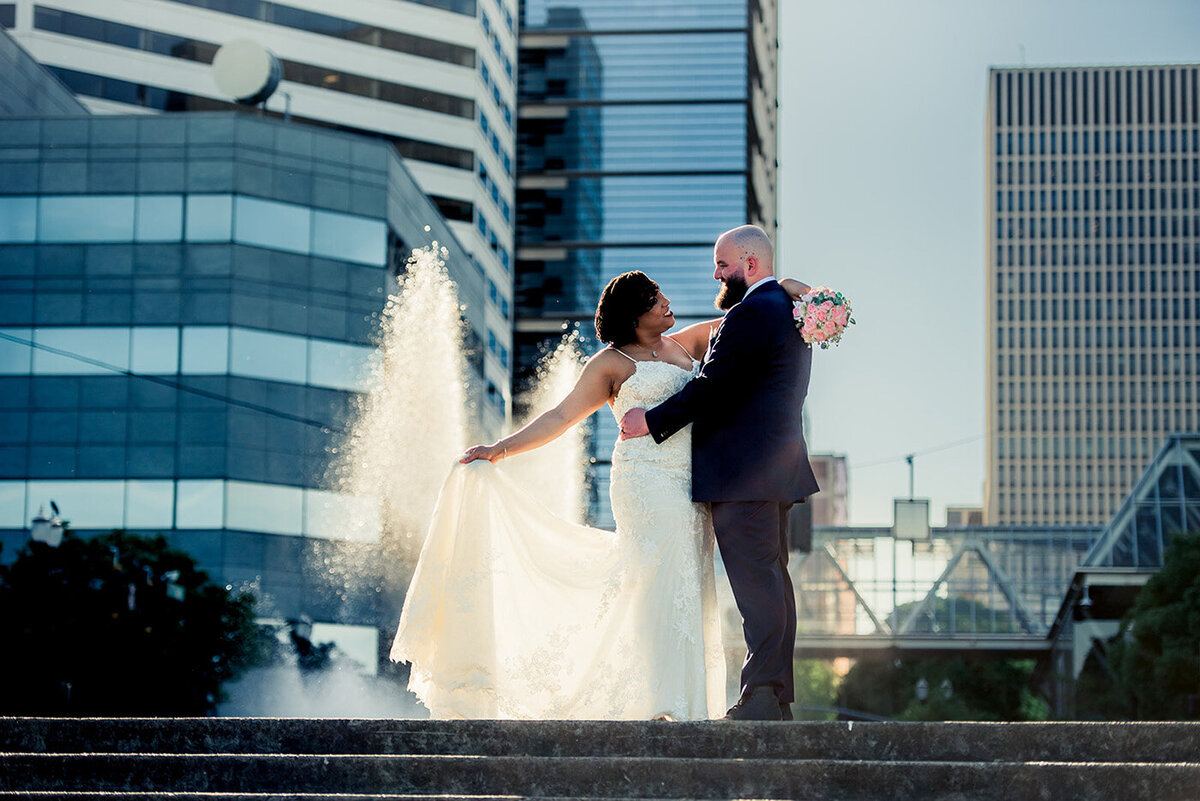 bride and groom with city