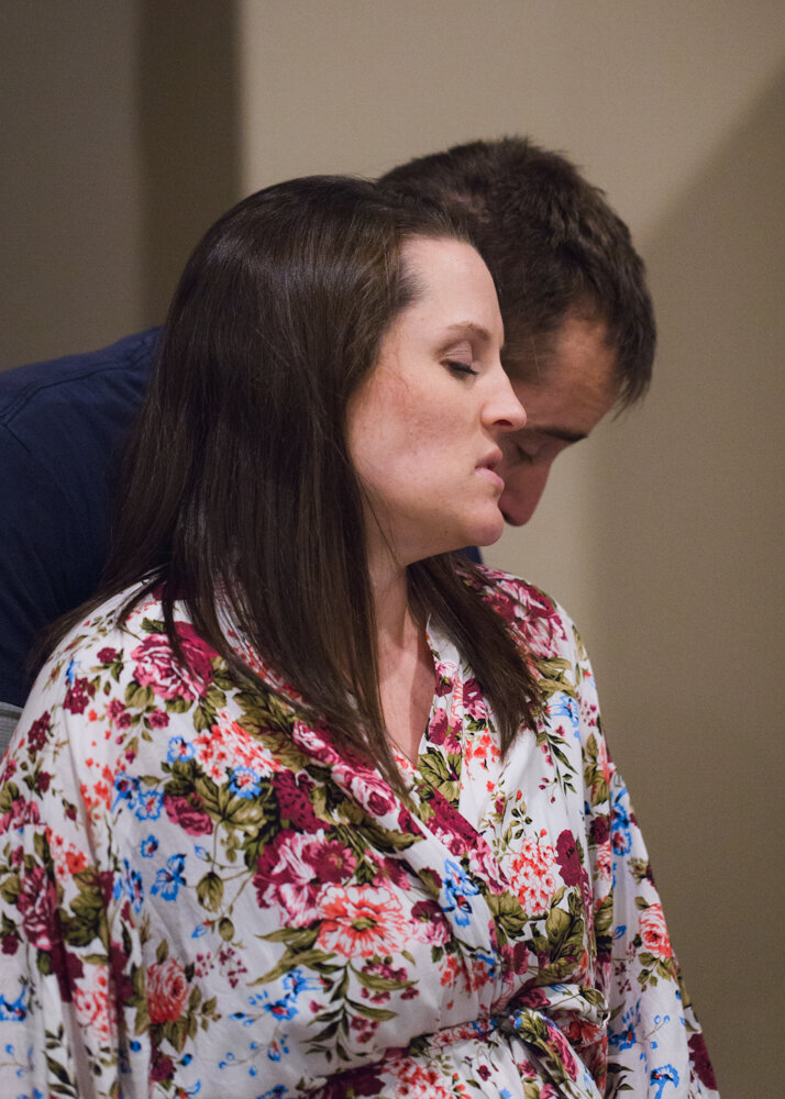 A woman sways with her husband during her home birth.