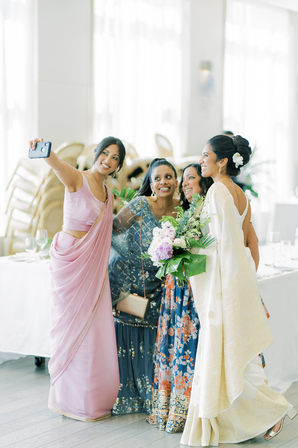 Bride and friends share a moment indian friends at the pearle hotel