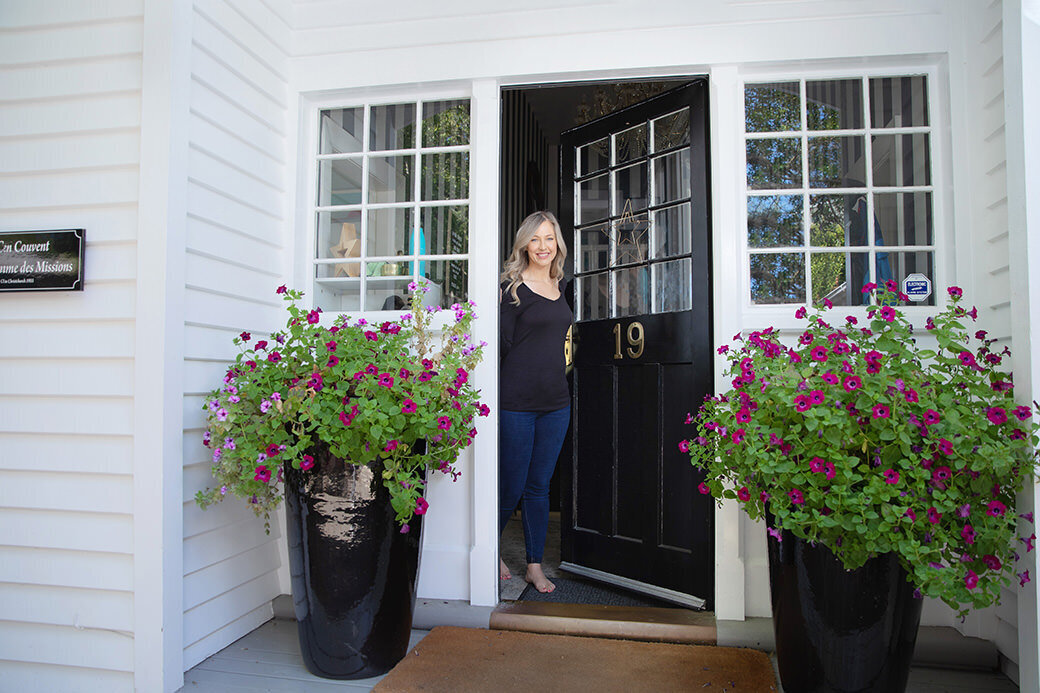 Woman at entrance to home business to welcome clients