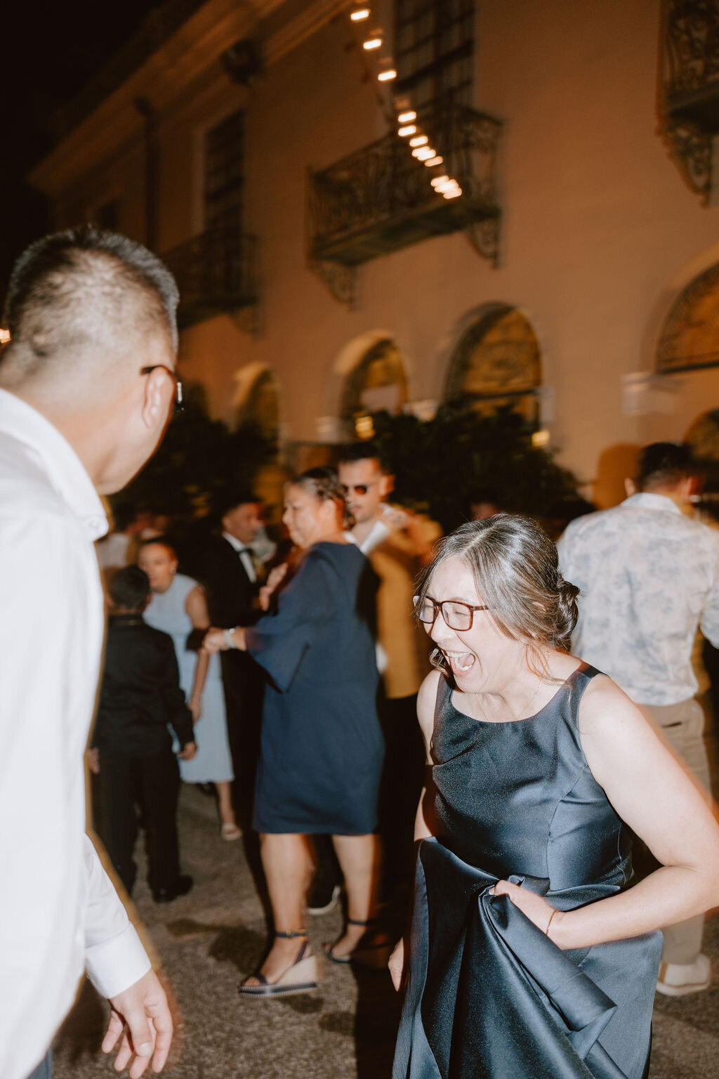 Guests dancing at wedding wearing shades of blue and white