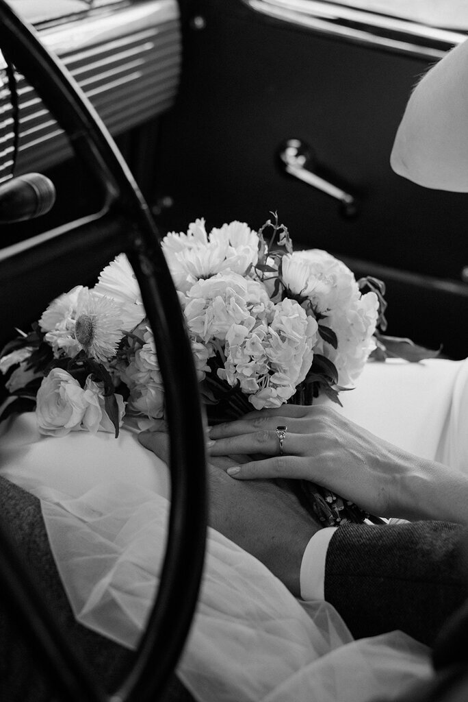 Couple holding hands in vintage wedding car, Coco & Ash, an intimate and modern wedding planner based in Calgary, Alberta.  Featured on the Brontë Bride Vendor Guide.