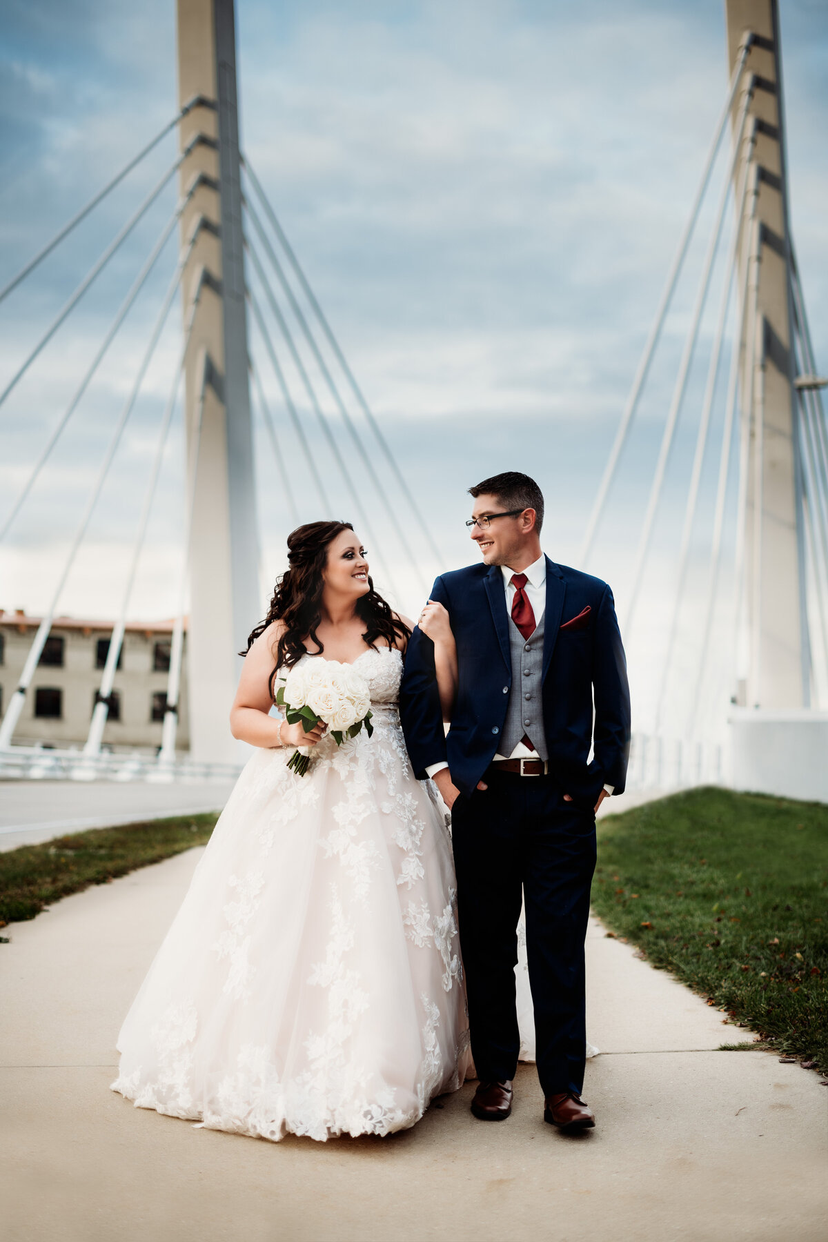 Bride and Groom walking in front of Milwaukee bridge