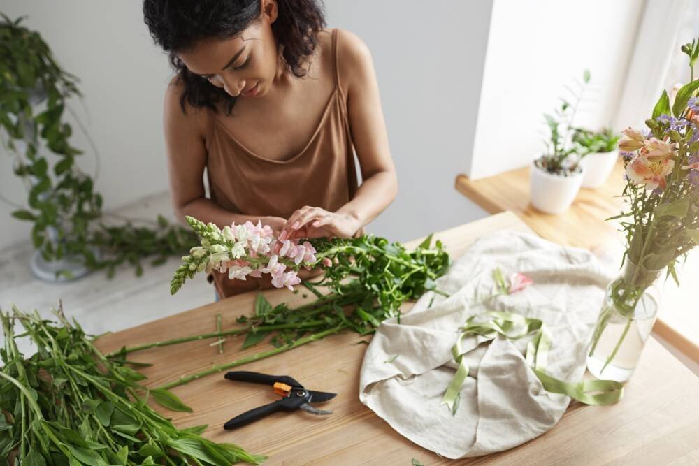 young-beautiful-african-woman-florist-taking-care-flowers-workplace-1