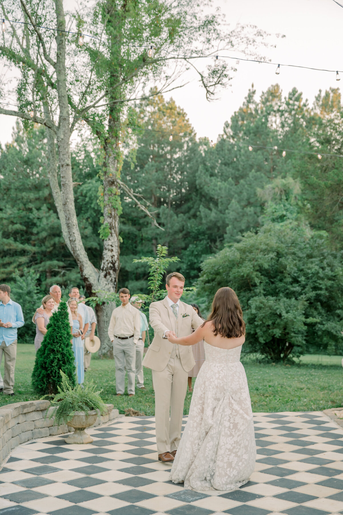 Bride and groom share first dance outside at Three Oaks Manor