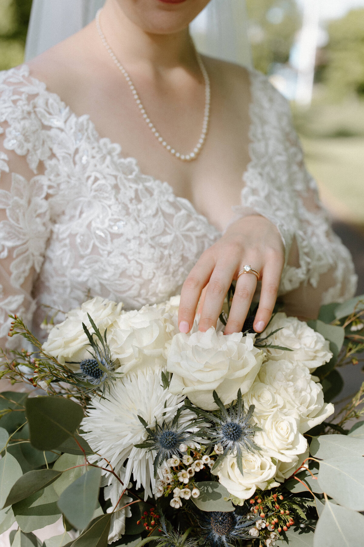 Close-up of the bride's bouquet and her wedding ring