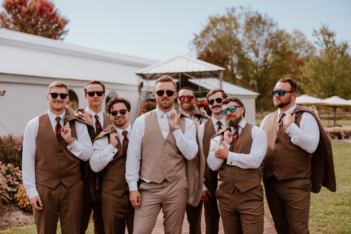 Groom posing with guests at Lippincott Manor.