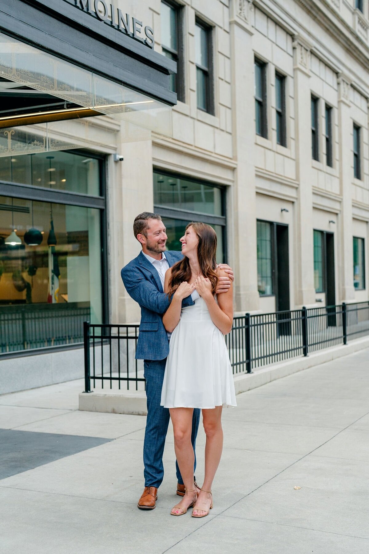 couple-smiling-hugging-downtown