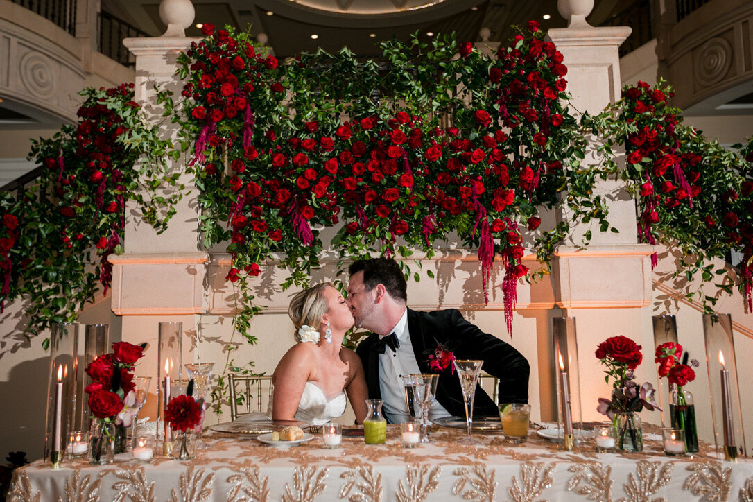 sweetheart table, staircase, southern smilax, bud vases, taper candles, hanging amaranthus, hair flowers