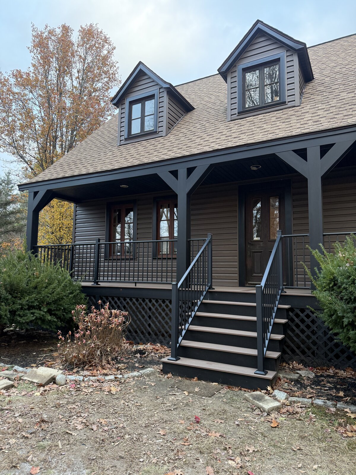 A View Of An Black and brown porch with black railings and black posts with brown decking
