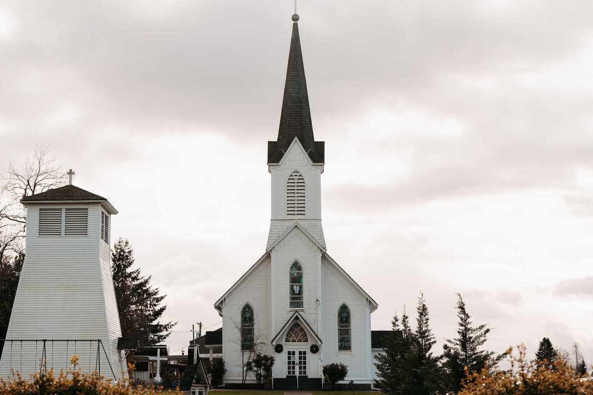 a white church with a tall steeple