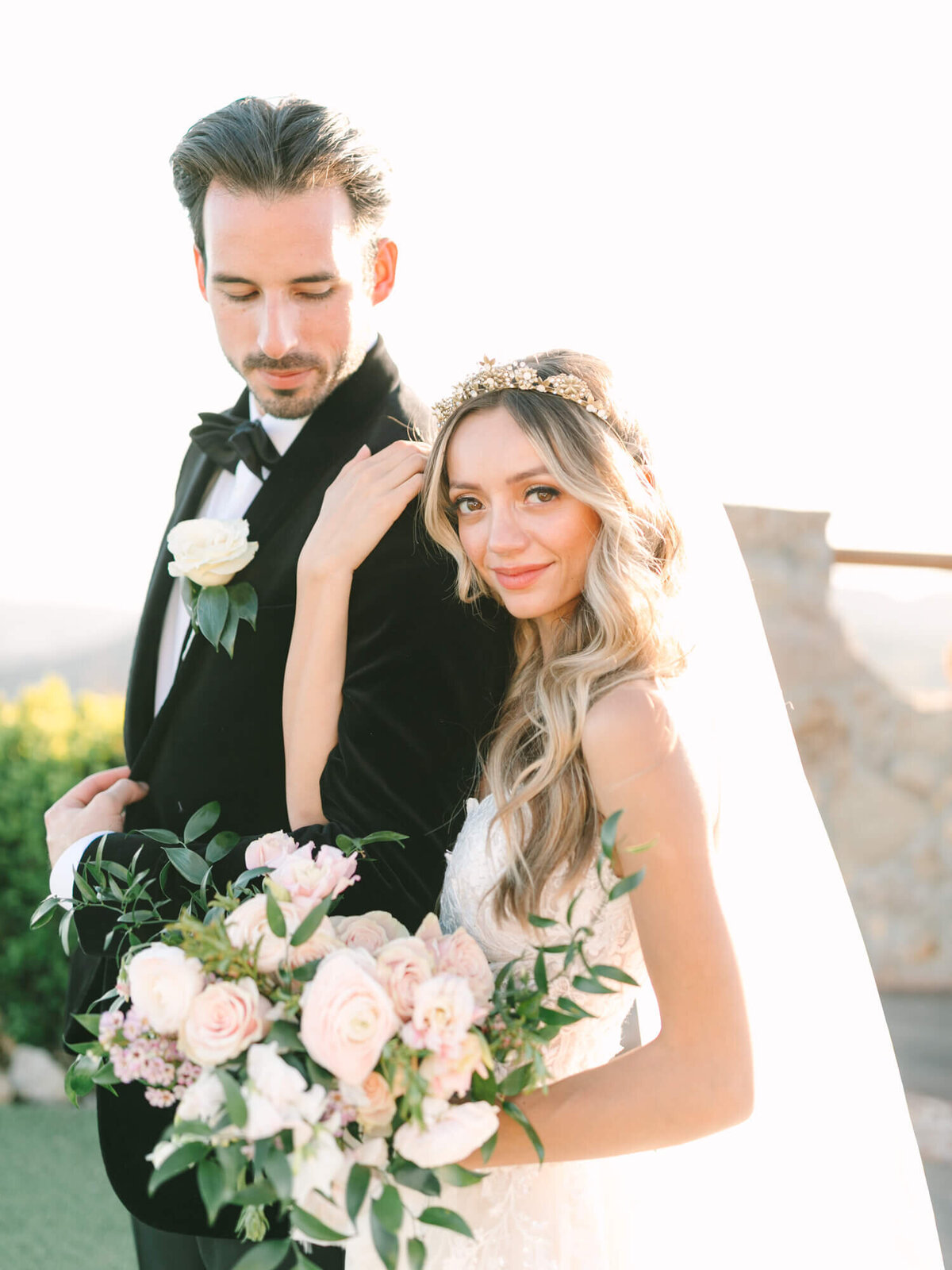 sunset photo of bride and groom looking at the camera